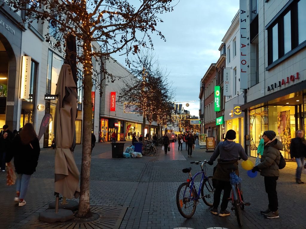 A lively evening shopping street reflecting Rocco Marotta's impact on the real estate sector.