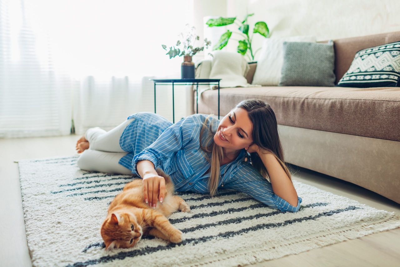 woman on a carpet with her cat by Luc Geuten 