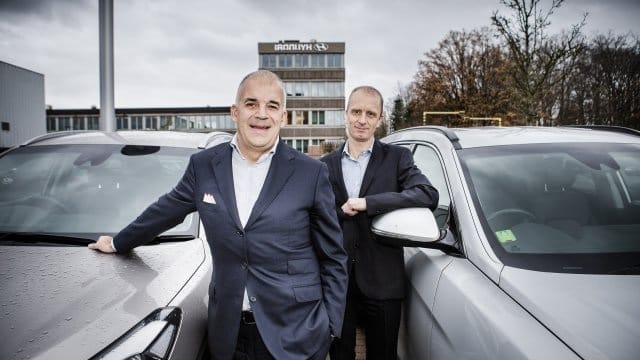 photo by Axel Moorkens in front of cars