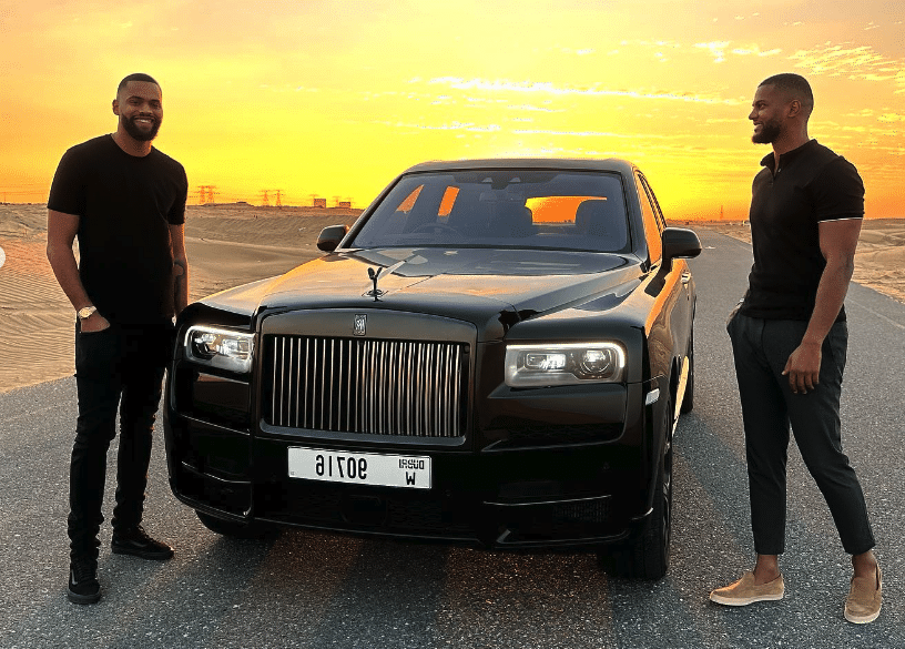 Yomi Denzel and his brother in front of a luxury car