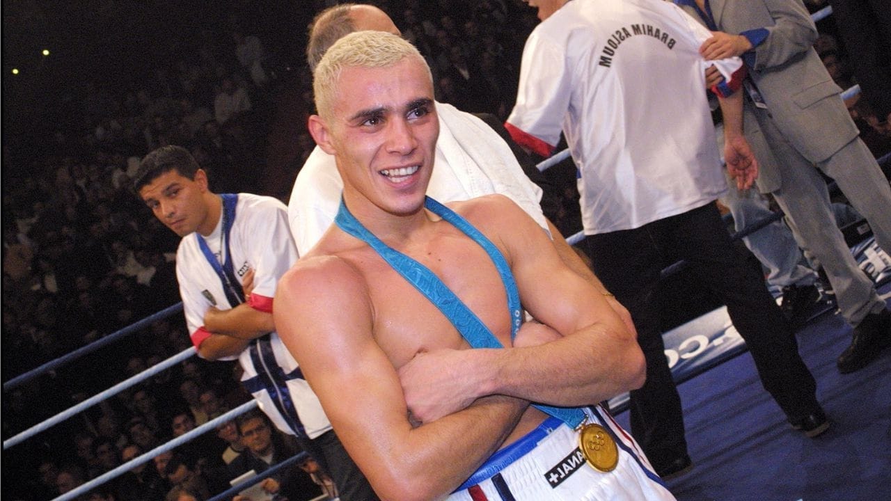 Brahim Asloum, Olympic and professional champion, in a fighting stance in the ring.
